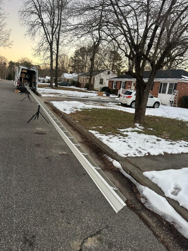 Onsite seamless gutter machine forming a continuous aluminum gutter for a Virginia home