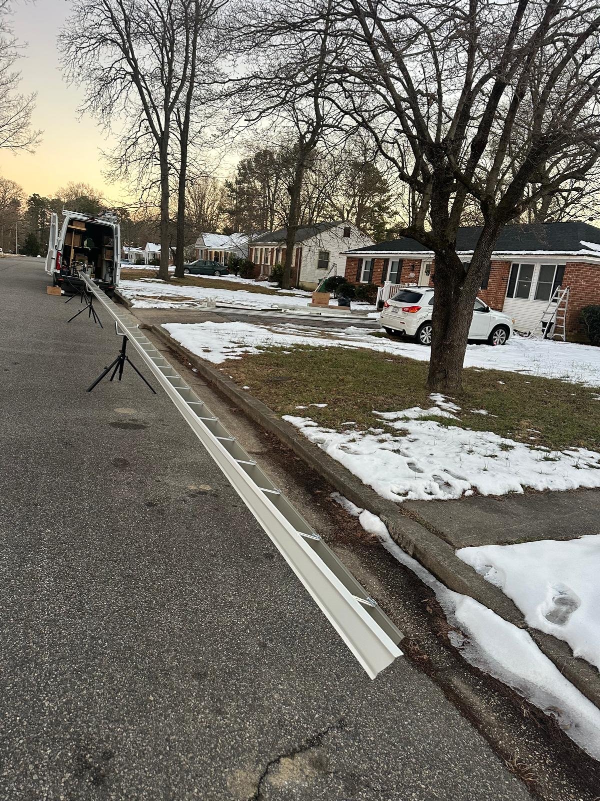 Onsite seamless gutter machine forming a continuous aluminum gutter for a Virginia home