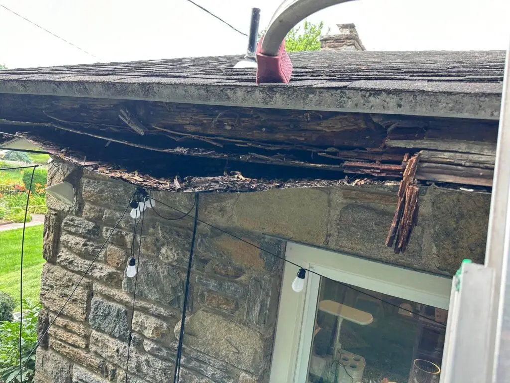 Severe fascia board damage caused by long-term gutter leaks and improper installation.