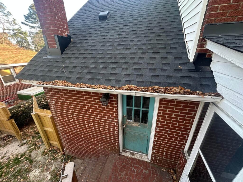 Old gutter system with debris buildup before replacement in Chesapeake Virginia