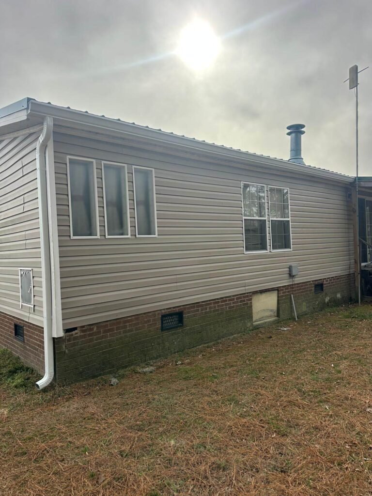 New seamless gutters installed along roof edge of home in Conway North Carolina
