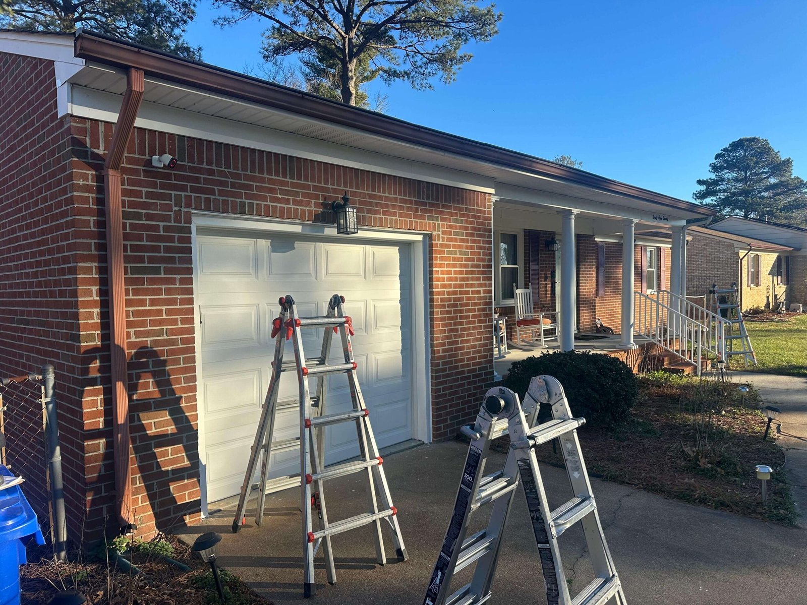 Loose sectional gutters on a Portsmouth Virginia home before seamless gutter installation