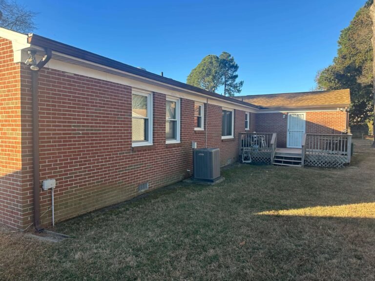 Aging sectional gutters on a brick home in Portsmouth VA before gutter replacement project
