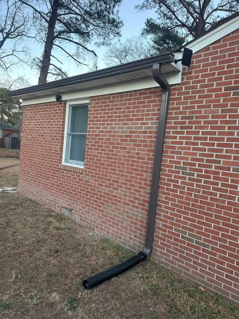 downspout extension directing rainwater away from the foundation