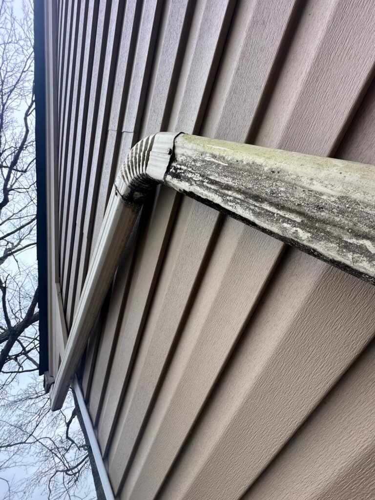 Old leaking sectional gutter with visible staining and separation before seamless gutter replacement in Newport News VA