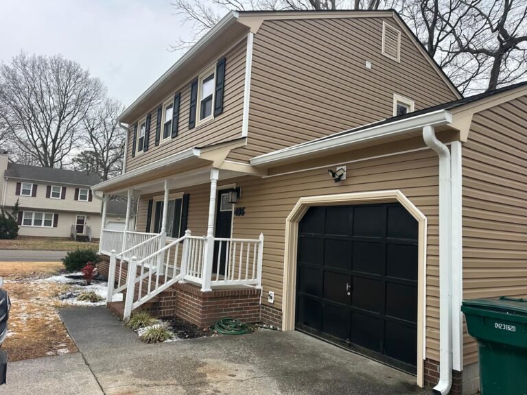 Seamless gutter installation above garage replacing old sectional gutters in Newport News VA