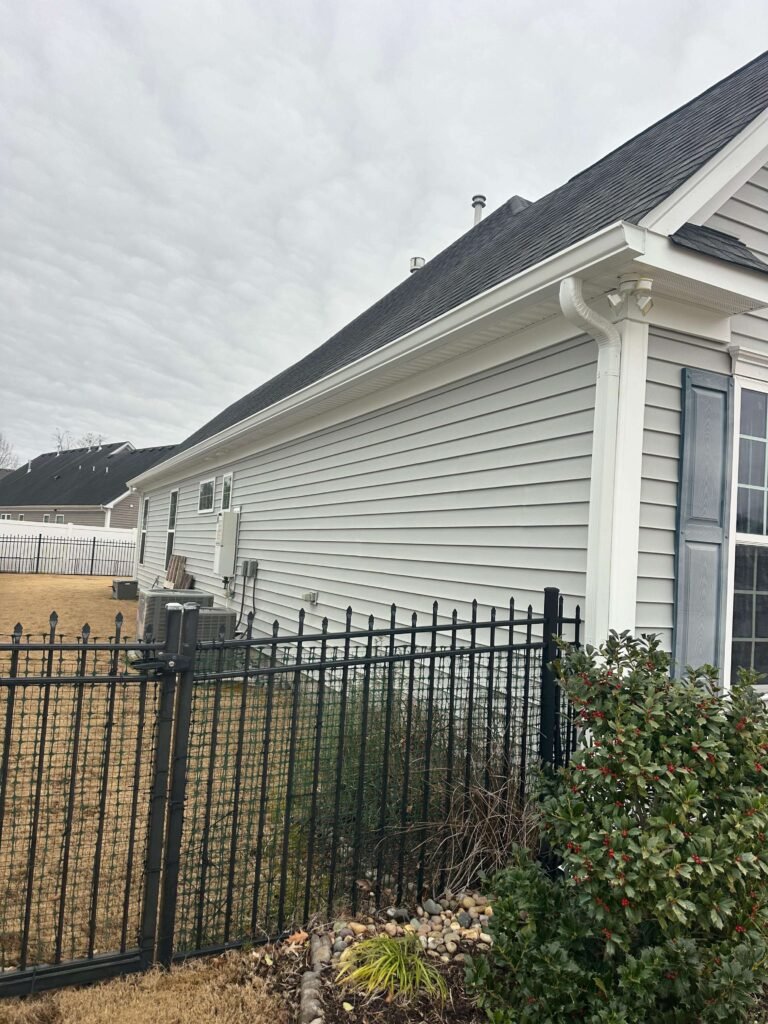 seamless gutter installation along side roofline of Chesapeake VA home