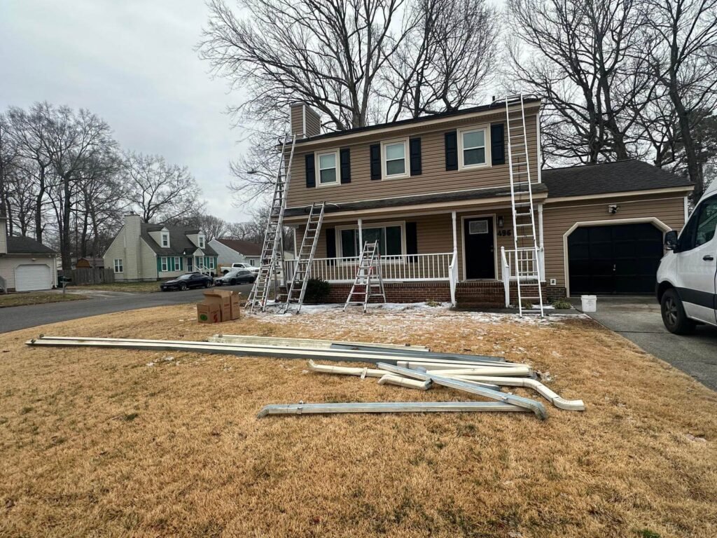 Seamless gutter installation in progress on Virginia Beach residential home by Gutter Masters Pro