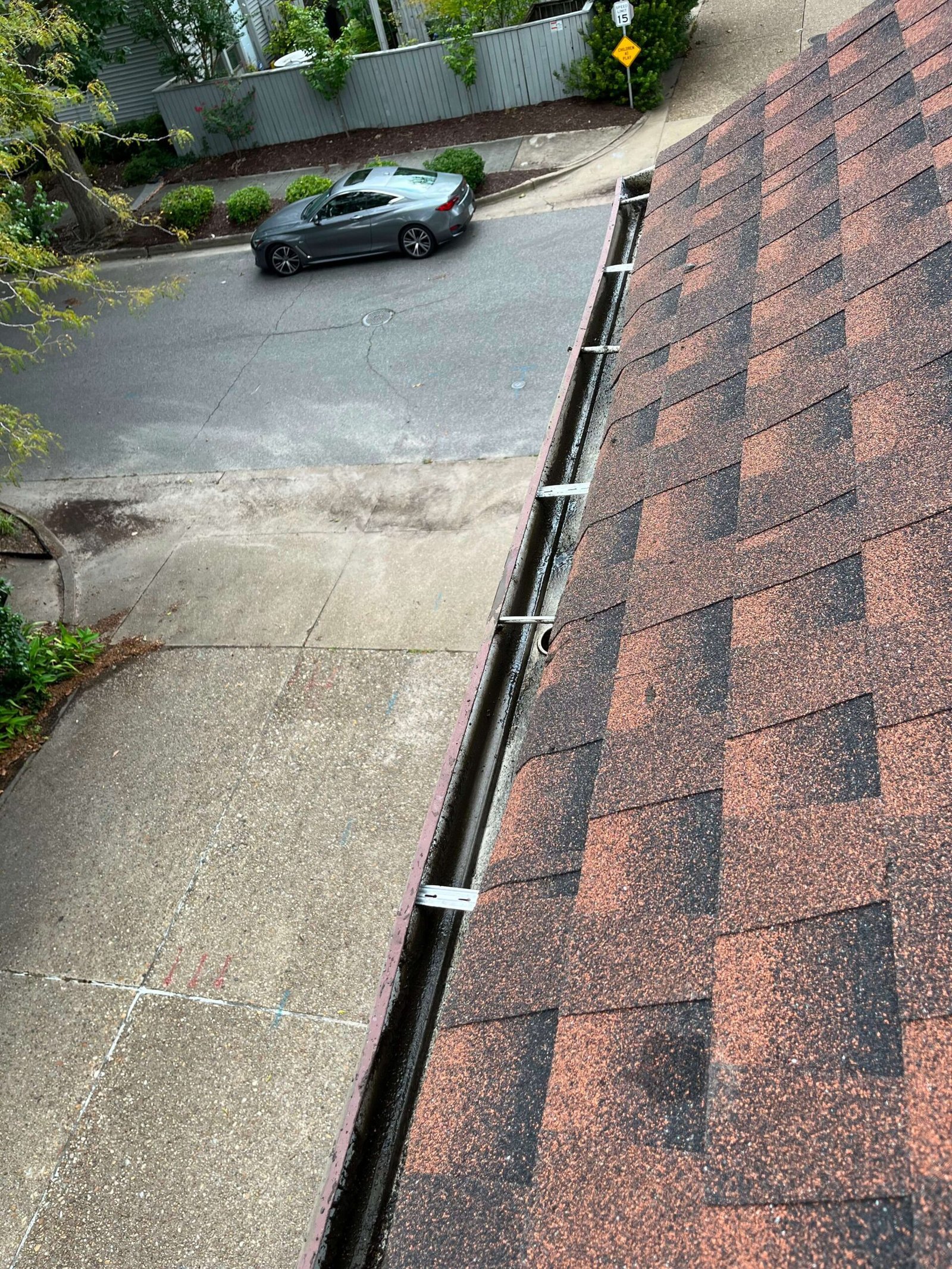 Second-story gutter fully cleared after professional cleaning in Virginia Beach