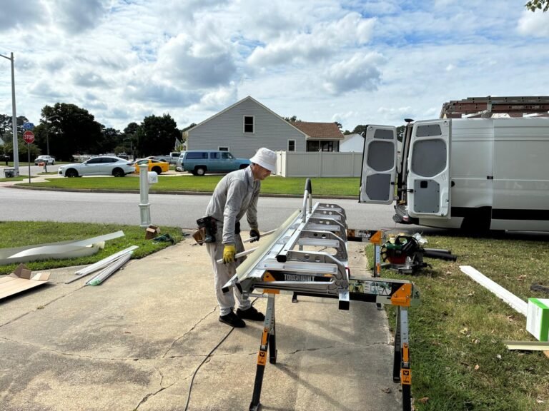 Technician bending aluminum trim coil to size at the on-site work station in Chesapeake, VA
