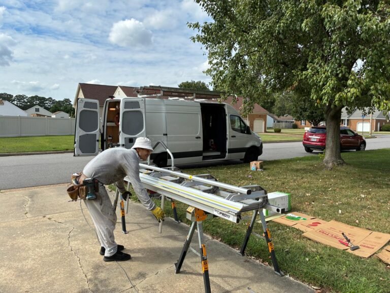 On-site trim coil work station and service van during fascia wrap fabrication in Chesapeake, VA