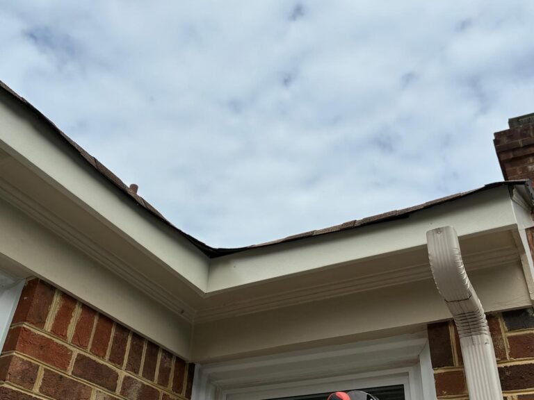 Fascia wrap installed along the roofline with the downspout still in place in Chesapeake, VA