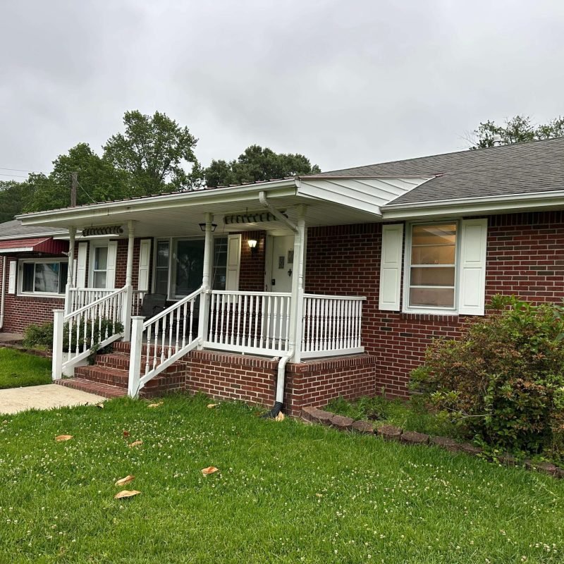After — complete installation — The finished home. New seamless gutters, new fascia, gutter filter system installed. The roofline that was silently causing structural damage is now properly protected.