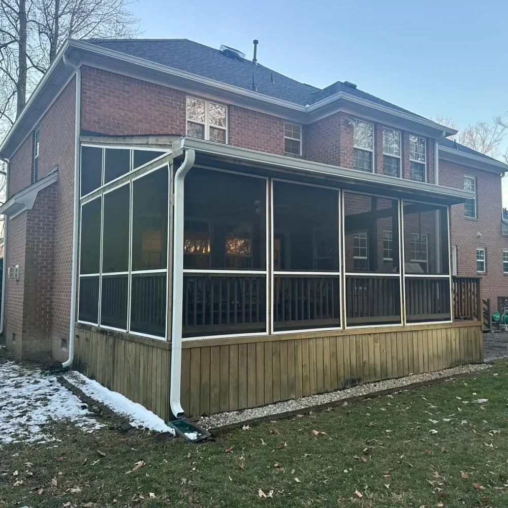 Williamsburg screened porch with new seamless gutters installed for long-lasting home protection.