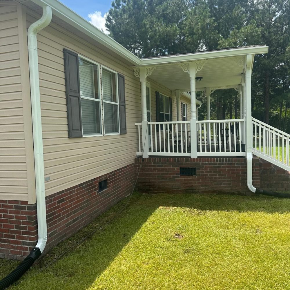 Professional gutter installation service with durable aluminum gutters on residential home