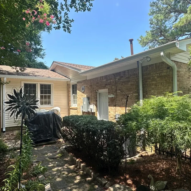 Virginia Beach home with new gutter installation to protect foundation and improve rainwater drainage.