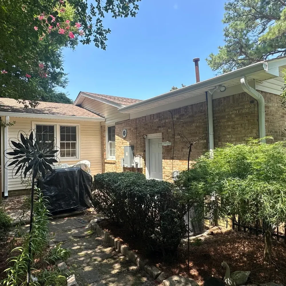 Virginia Beach home with new gutter installation to protect foundation and improve rainwater drainage.