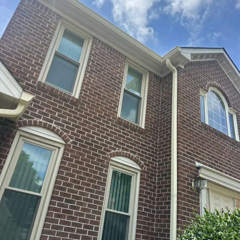 New gutter installation on a Virginia Beach two-story home for improved rainwater drainage and roof protection.