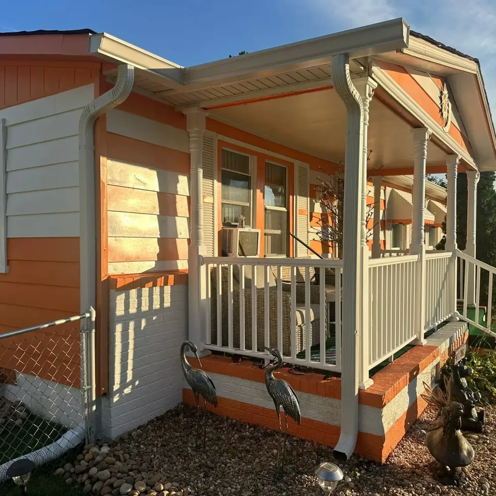 New gutter system with guard installation and repair work on a residential porch in Virginia for better rainwater flow.
