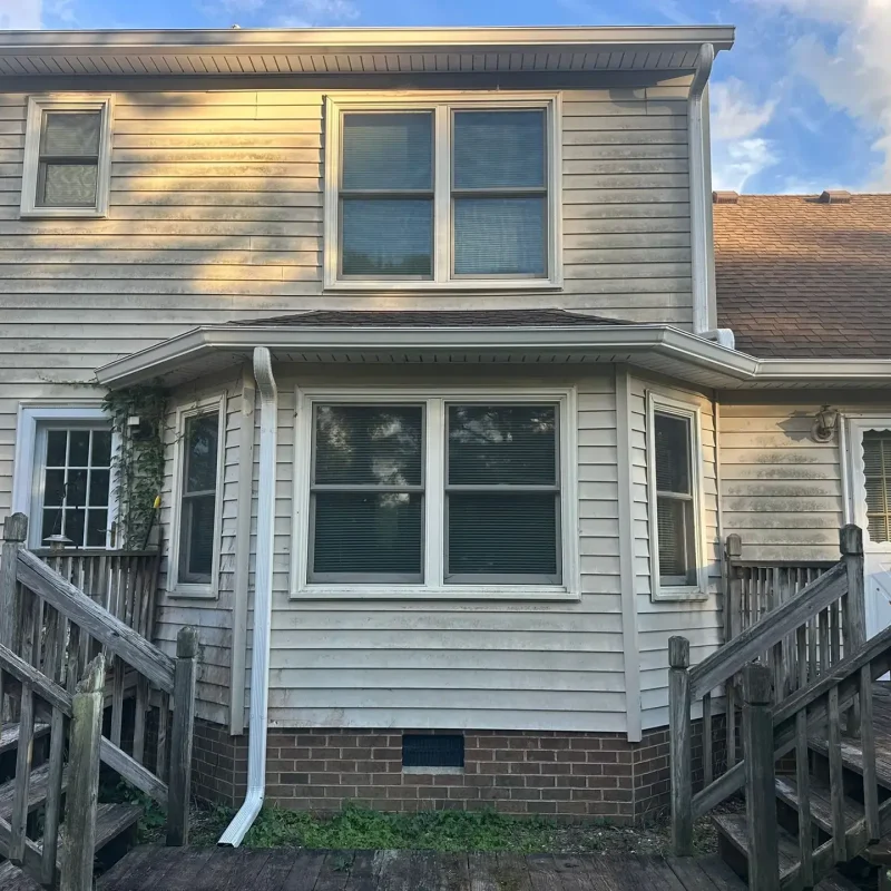 Installation of permanent clog-free gutter guards on a multi-story home in Smithfield, VA for zero maintenance.