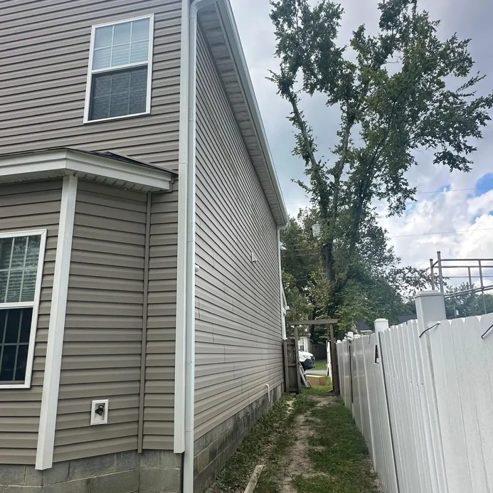 Installation of permanent clog-free gutter guards on a multi-story home in suffolk for zero maintenance.