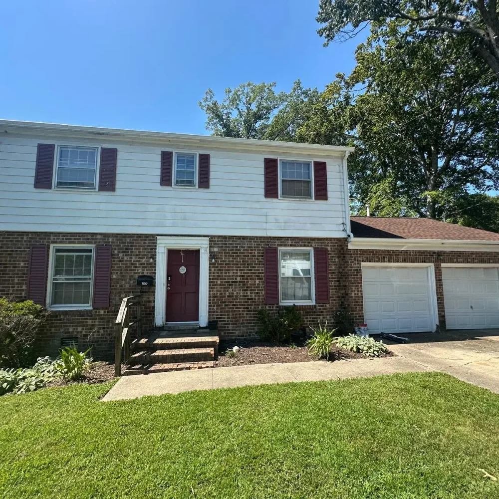 Installation of permanent clog-free gutter guards on a multi-story home in Norfolk for zero maintenance.