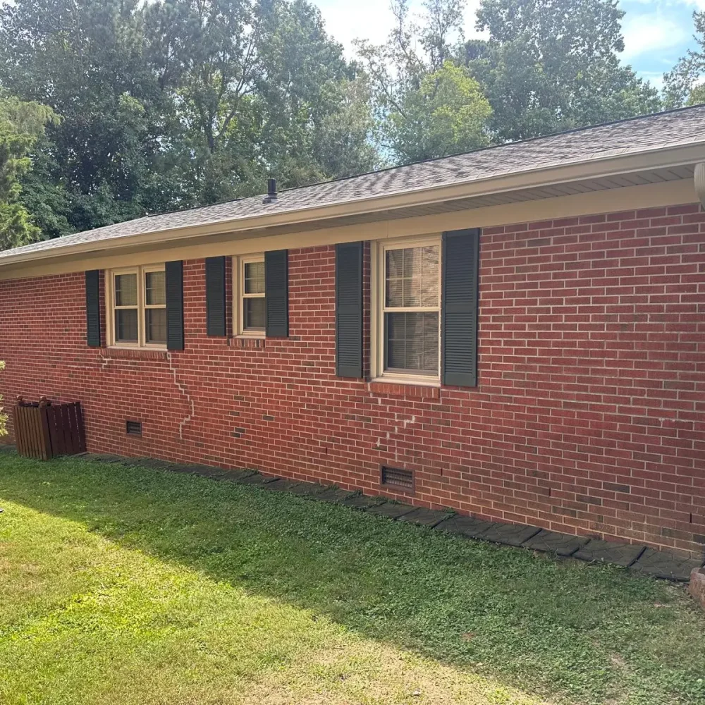 Completed seamless gutter installation on a brick house in Smithfield for maximum protection.