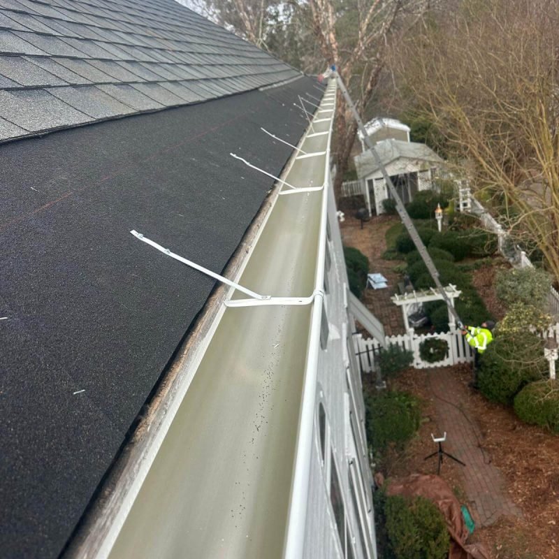 Close-up view explaining what are seamless gutters — one continuous aluminum gutter with no joints along the roofline.