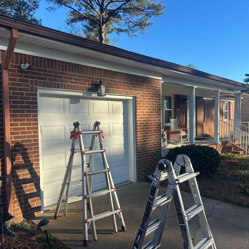 Loose sectional gutters on a Portsmouth Virginia home before seamless gutter installation