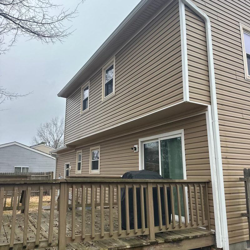 White seamless gutter system with properly aligned downspout installed in Newport News Virginia