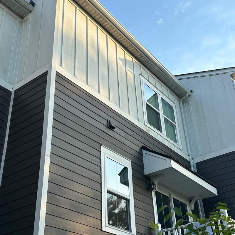 After — Third-floor roofline with new seamless extruded aluminum gutter installed. Flush against the fascia, correctly pitched, clean end cap termination. Full 20 ft run installed as a single continuous section with no mid-run joint.