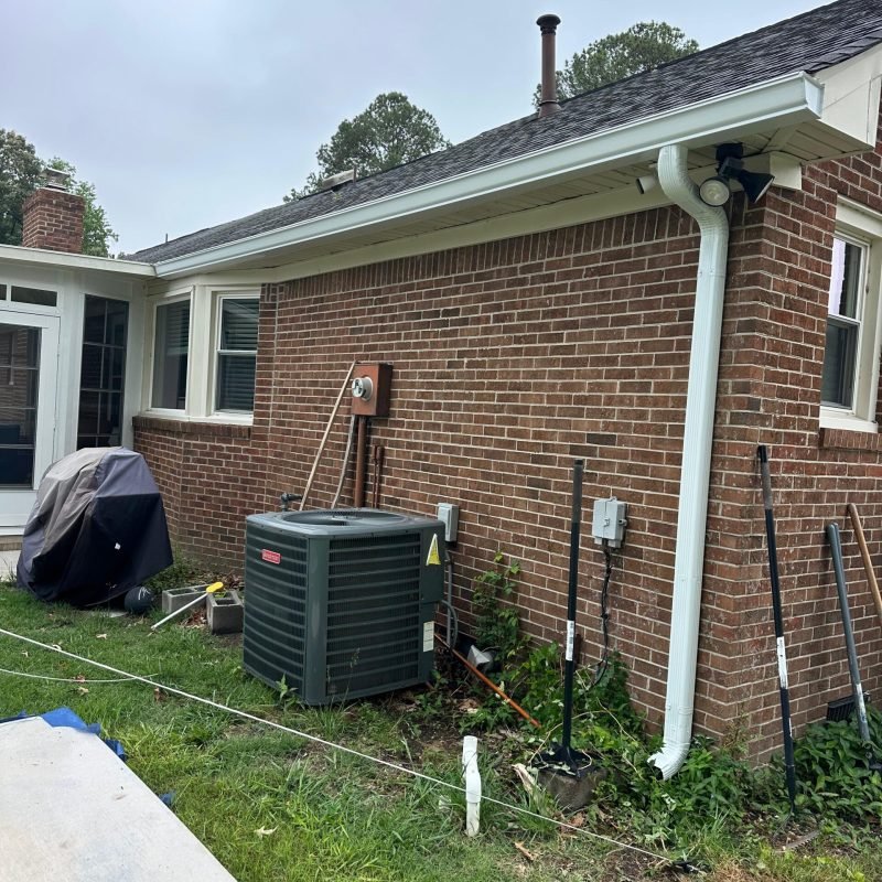 new white aluminum downspout installed on rear brick elevation — Chesapeake VA seamless gutter system completed